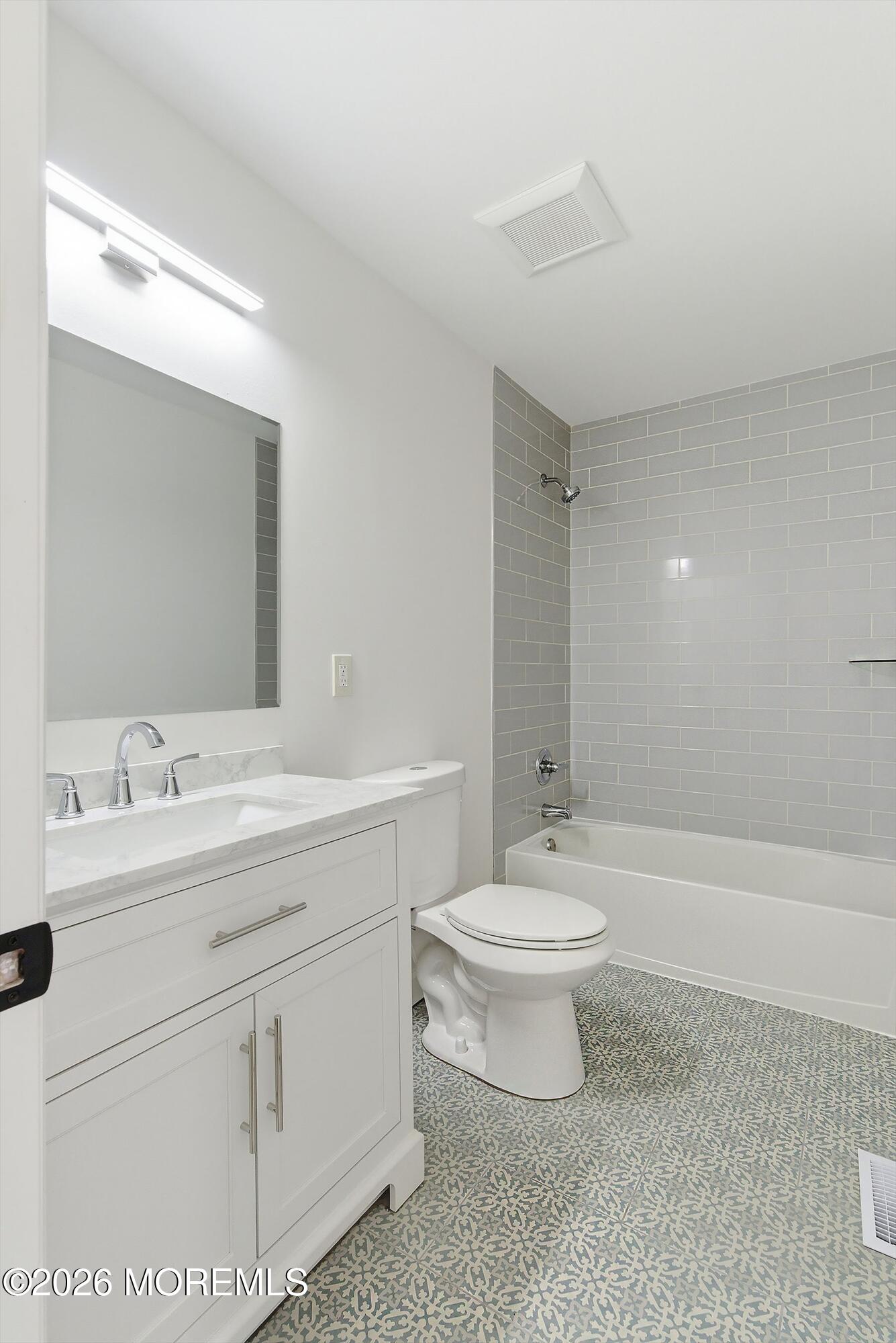 123 West 4th Street Howell, NJ 07731 - Photo 22 of 25 a bathroom with a toilet a sink a mirror and bathtub