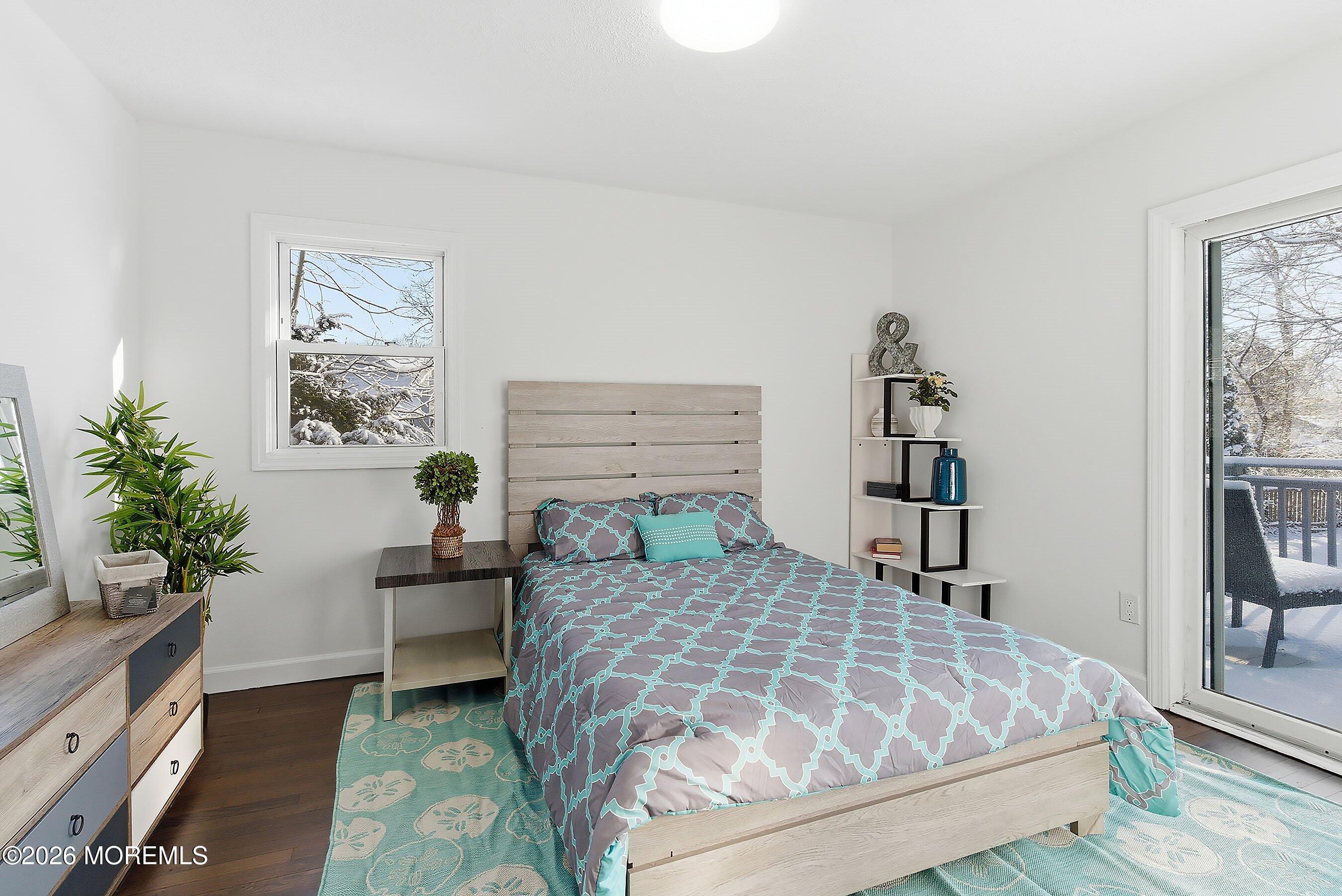 123 West 4th Street Howell, NJ 07731 - Photo 24 of 25 a bed sitting in a bedroom next to a window with potted plant