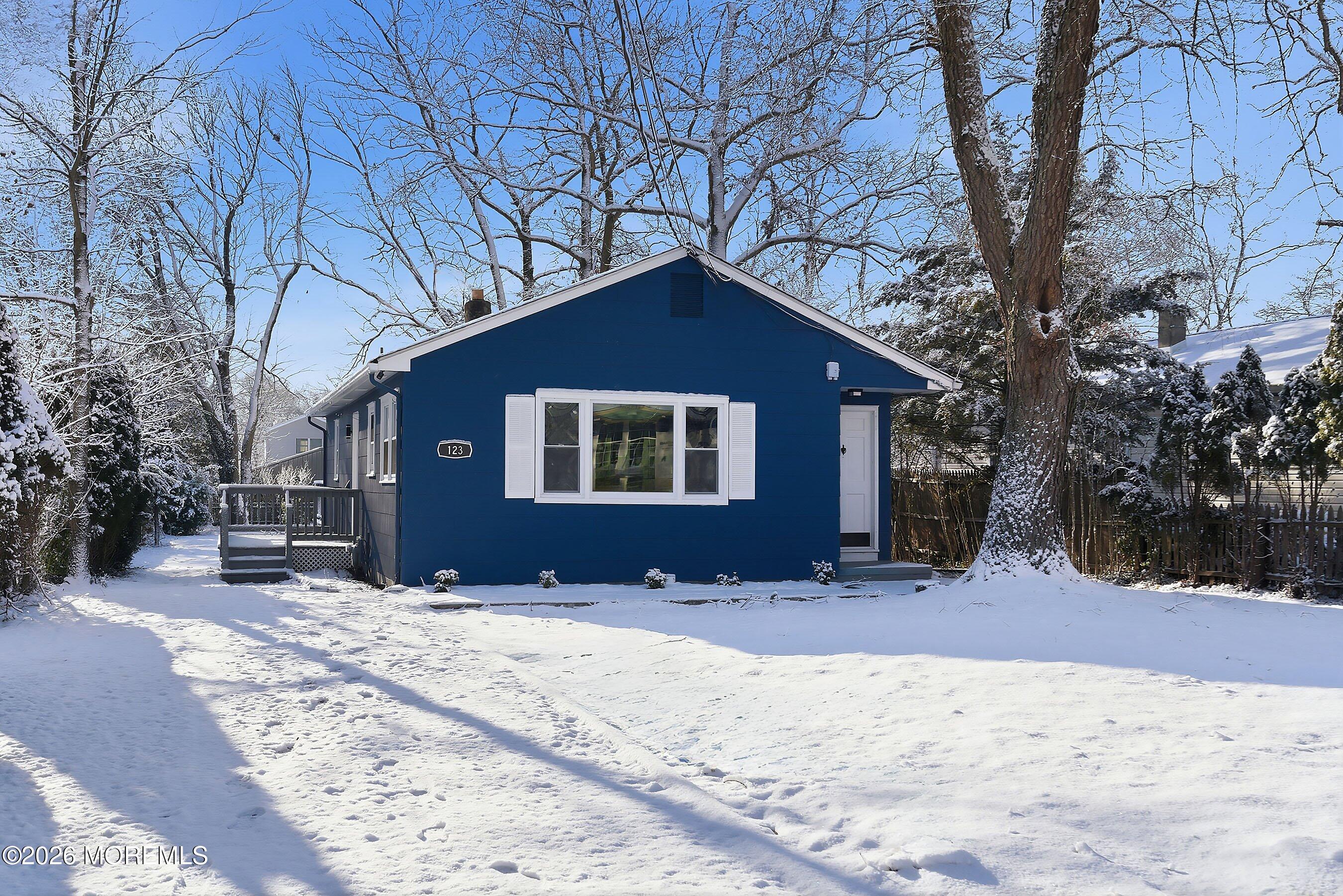 123 West 4th Street Howell, NJ 07731 - Photo 9 of 25 a front view of a house with a yard covered in snow