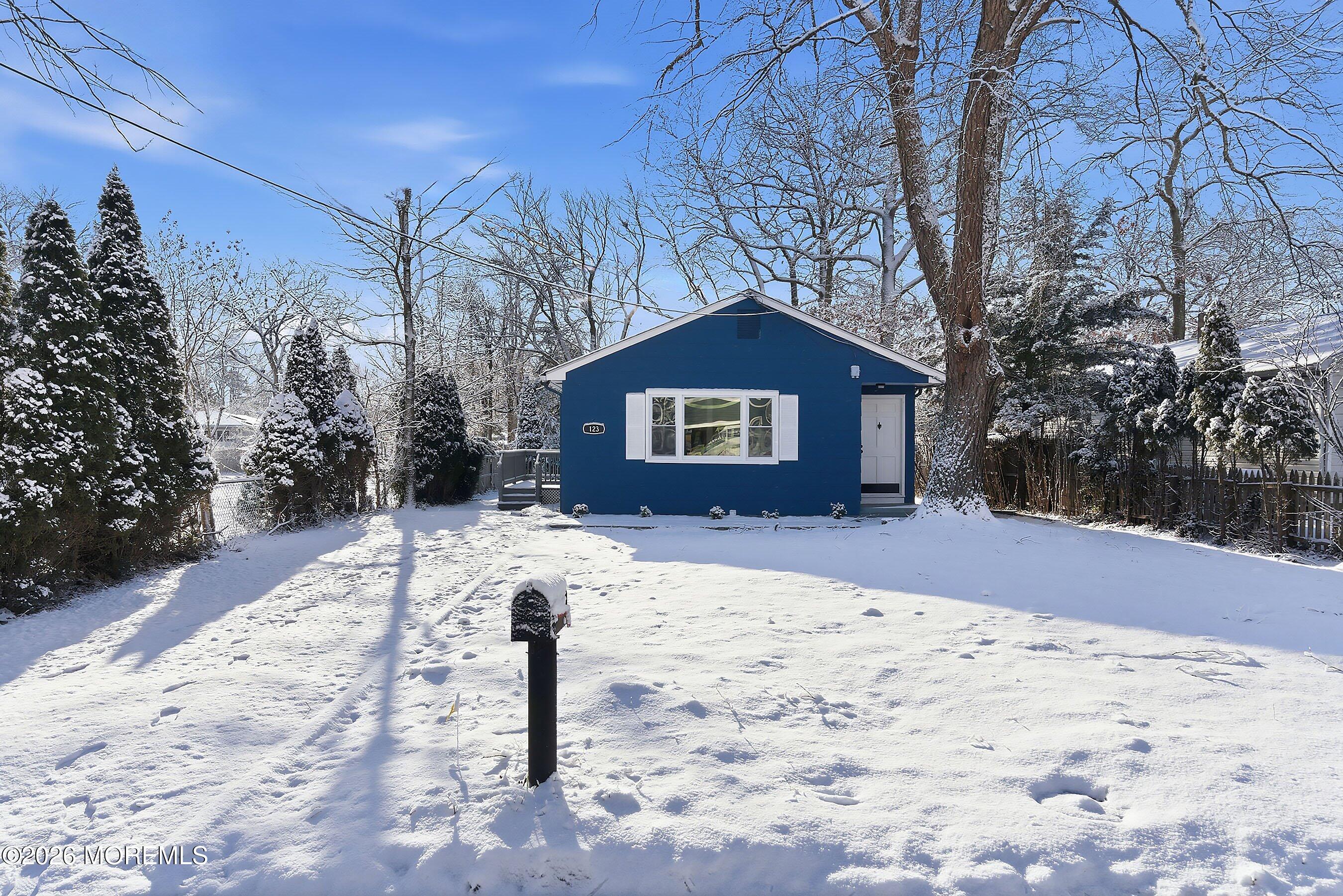 123 West 4th Street Howell, NJ 07731 - Photo 10 of 25 a front view of a house with a yard covered in snow