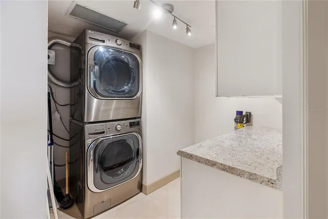 a bathroom with a granite countertop shower sink and vanity