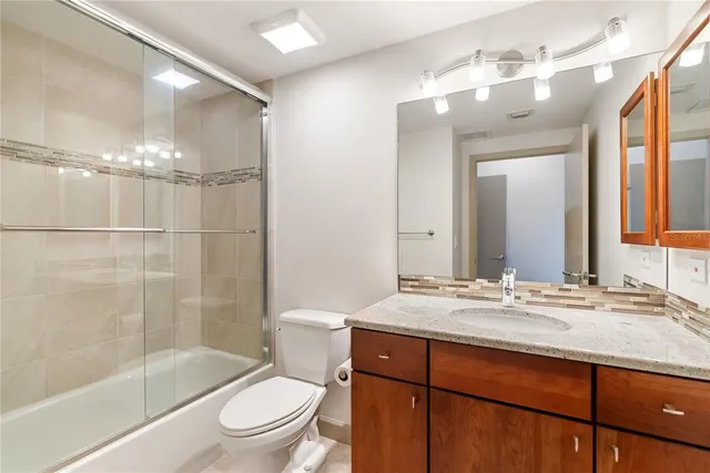 a view of a bedroom with a bed and a window