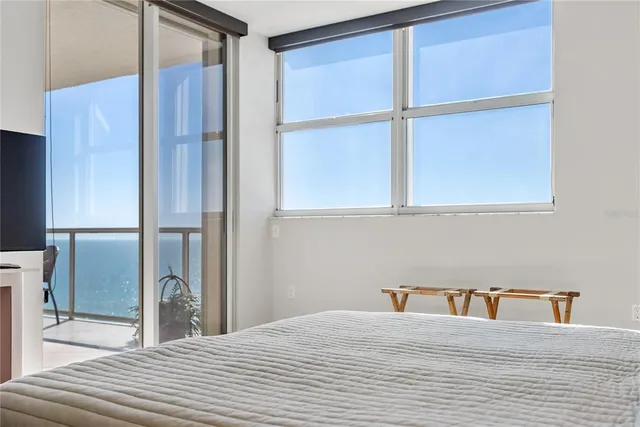 a living room with a couch and chandelier