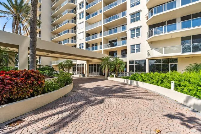 a view of a building with garden and sitting area