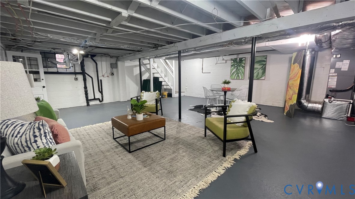 1008 Bevridge Road Richmond, VA 23226 - Photo 40 of 43 a living room with furniture and a chandelier