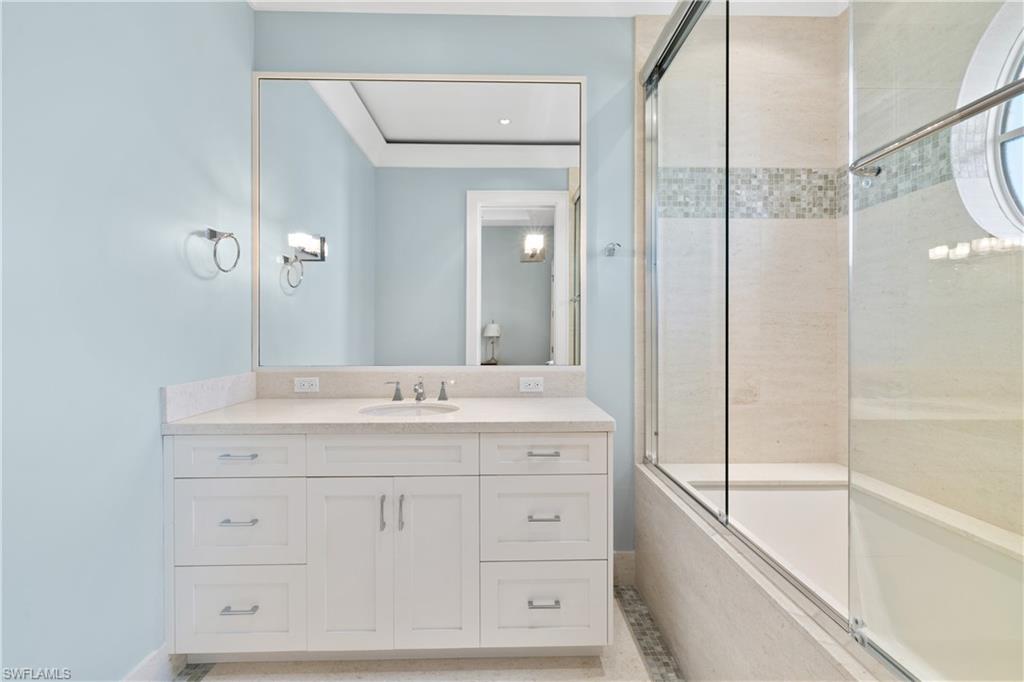1270 Gulf Shore Boulevard South Naples, FL 34102 - Photo 11 of 24 a bathroom with a granite countertop sink mirror and a bathtub