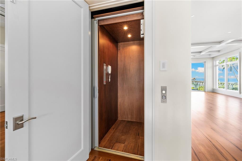 1270 Gulf Shore Boulevard South Naples, FL 34102 - Photo 12 of 24 wooden floor in a hall with an entryway