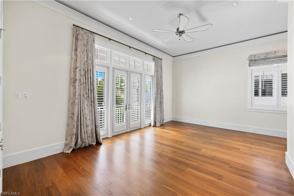 1270 Gulf Shore Boulevard South Naples, FL 34102 - Photo 13 of 24 wooden floor in an empty room with a window