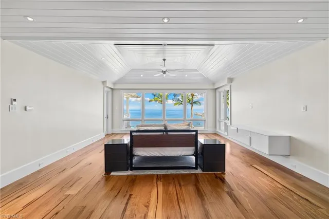 a storage room with wooden floor and windows