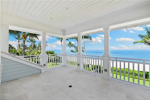 a living room with furniture wooden floor and a large window