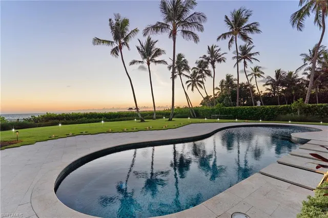a view of swimming pool with a table and chairs