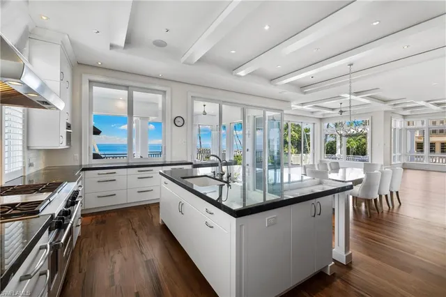 a kitchen with stainless steel appliances granite countertop a sink a stove and a refrigerator