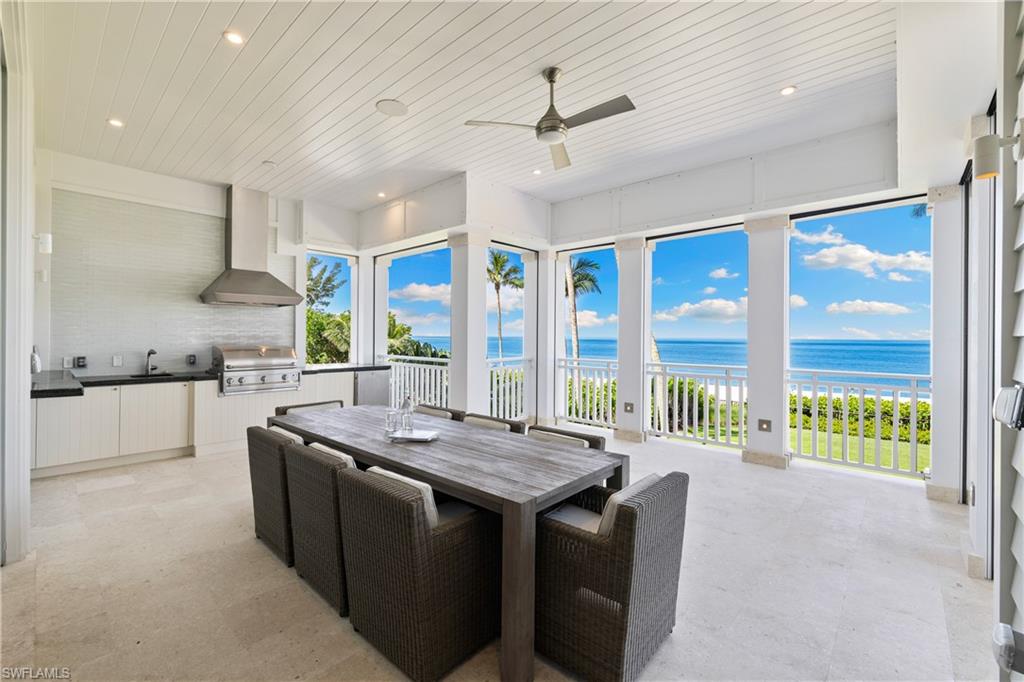 1270 Gulf Shore Boulevard South Naples, FL 34102 - Photo 23 of 24 a kitchen with stainless steel appliances granite countertop a sink a stove and a refrigerator
