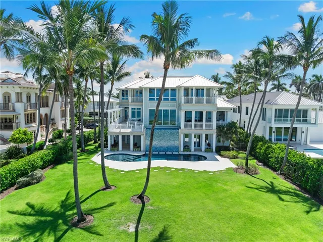 a view of house with a backyard and a patio