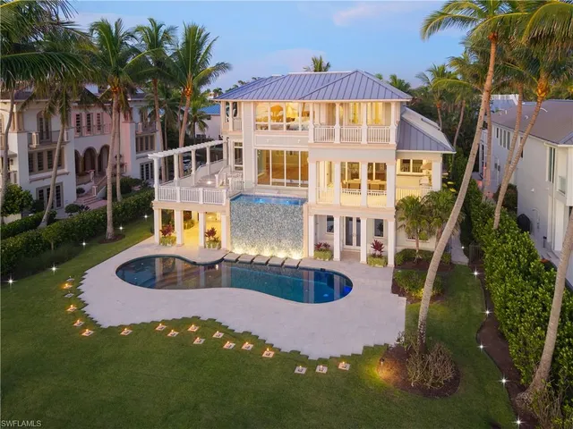 a front view of residential houses with yard and swimming pool