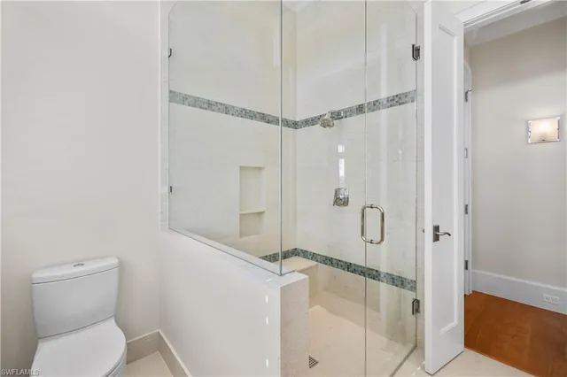 a bathroom with a shower and toilet