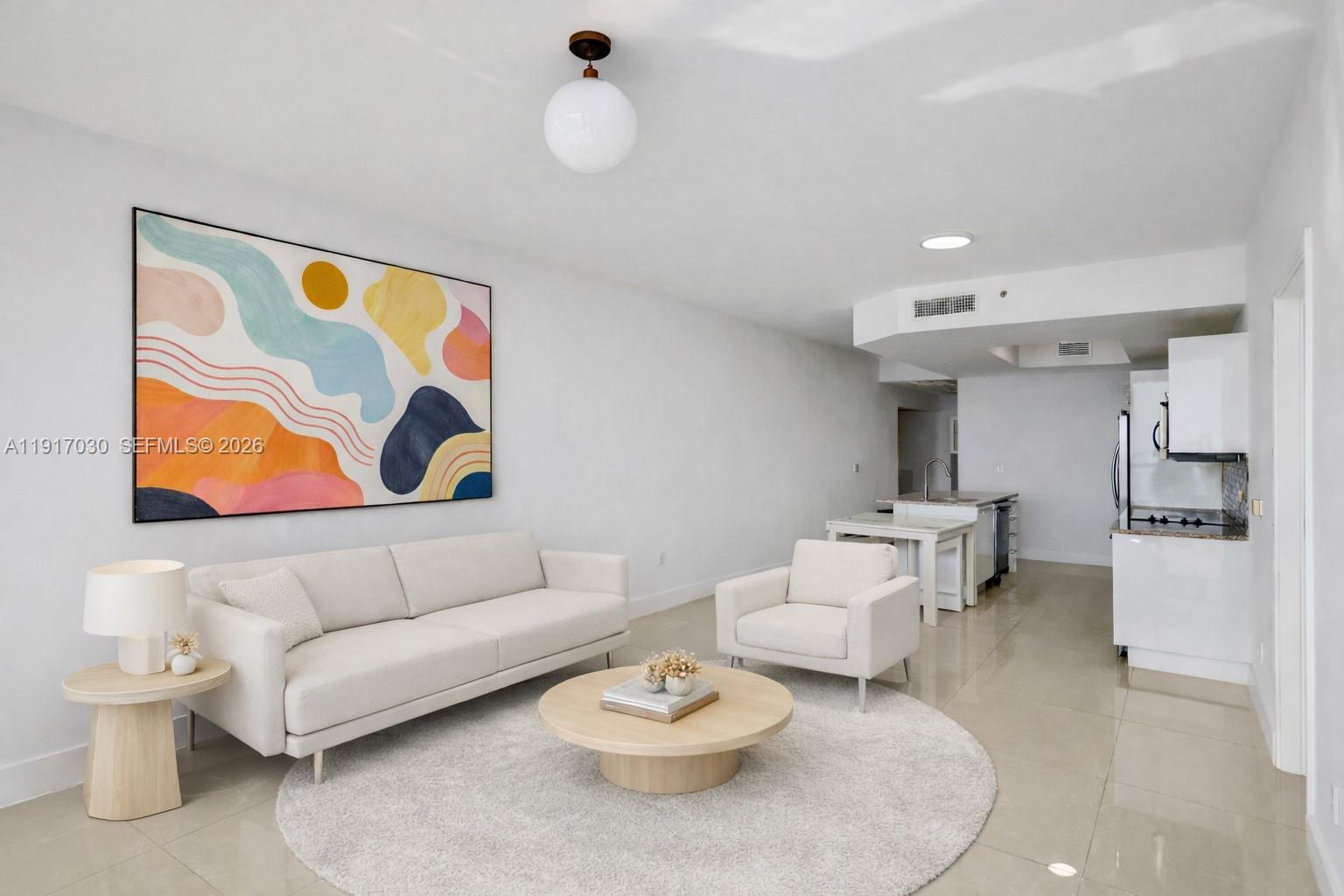 888 Biscayne Boulevard, Unit 2904 Miami, FL 33132 - Photo 6 of 27 a living room with furniture and white walls