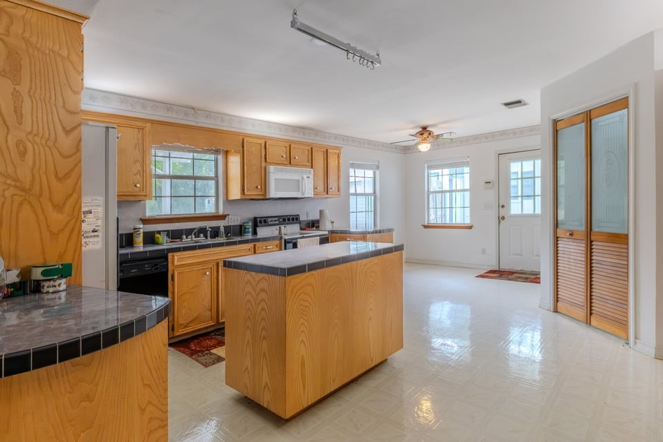 483 Riverside Drive Palacios, TX 77465 - Photo 10 of 41 a kitchen with stainless steel appliances granite countertop a stove and a sink