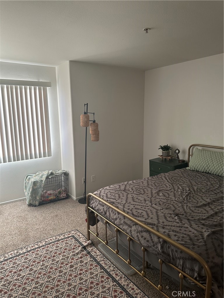 220 West Walnut Avenue, Unit B Rialto, CA 92376 - Photo 11 of 14 a bedroom with a bed and a window