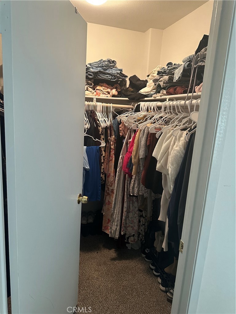 220 West Walnut Avenue, Unit B Rialto, CA 92376 - Photo 12 of 14 a view of walk in closet with clothes and shoes