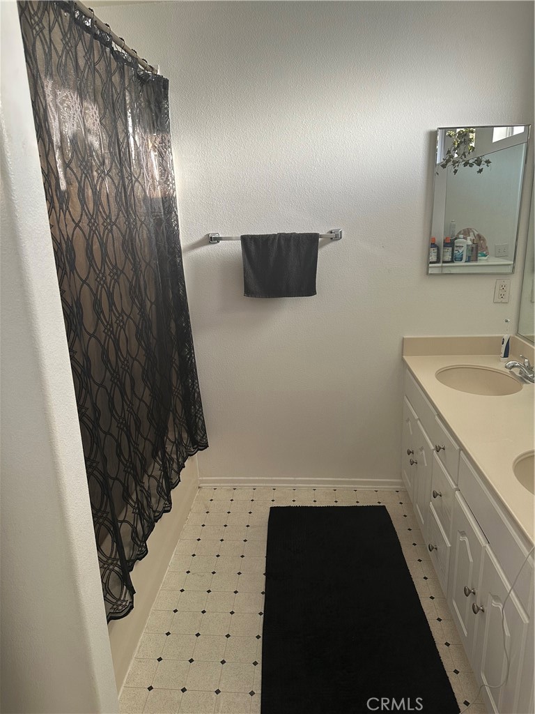 220 West Walnut Avenue, Unit B Rialto, CA 92376 - Photo 13 of 14 a bathroom with a sink and a mirror