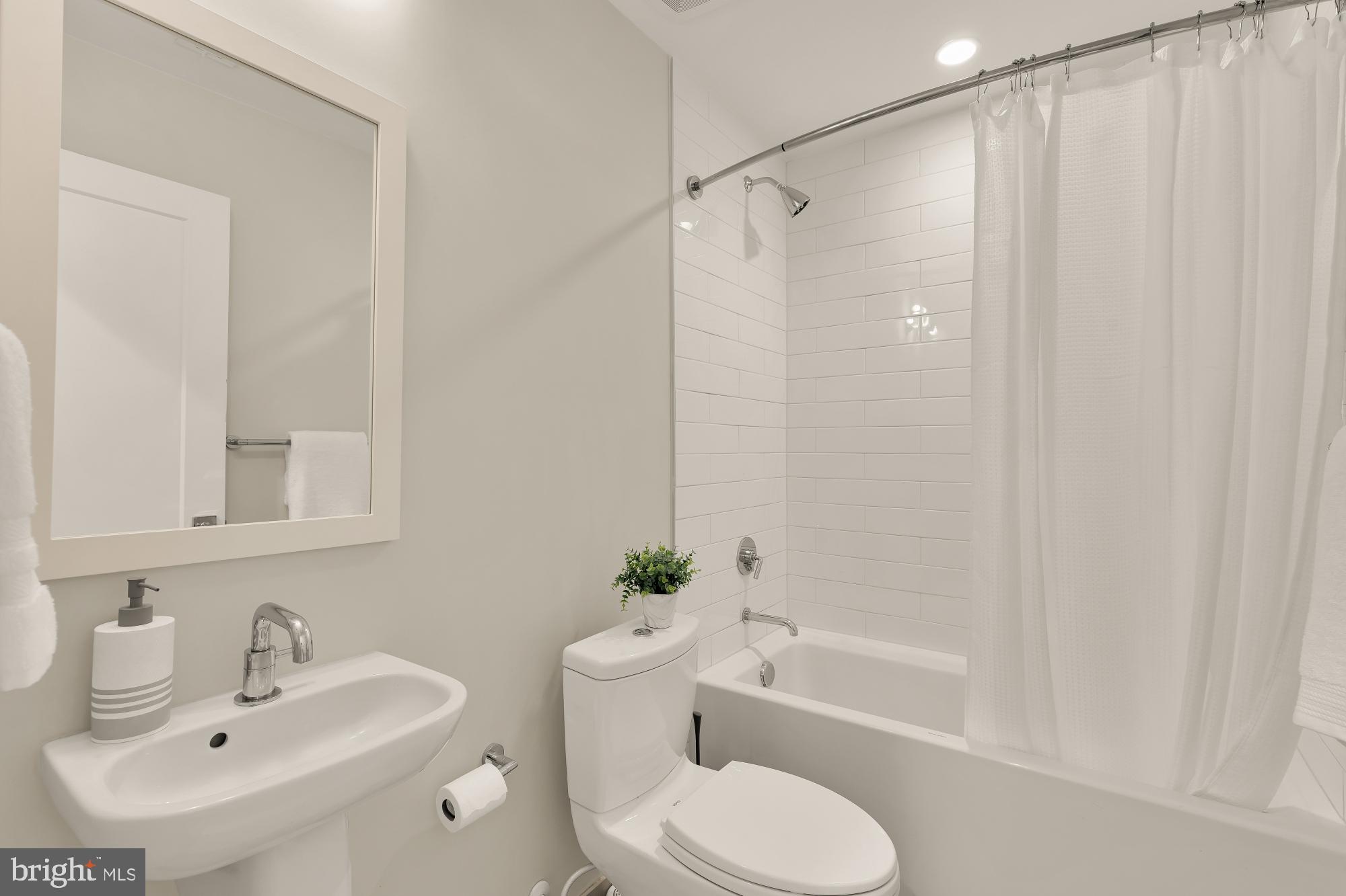 415 Guethler's Way Washington, DC 20003 - Photo 13 of 32 a bathroom with a sink toilet and shower