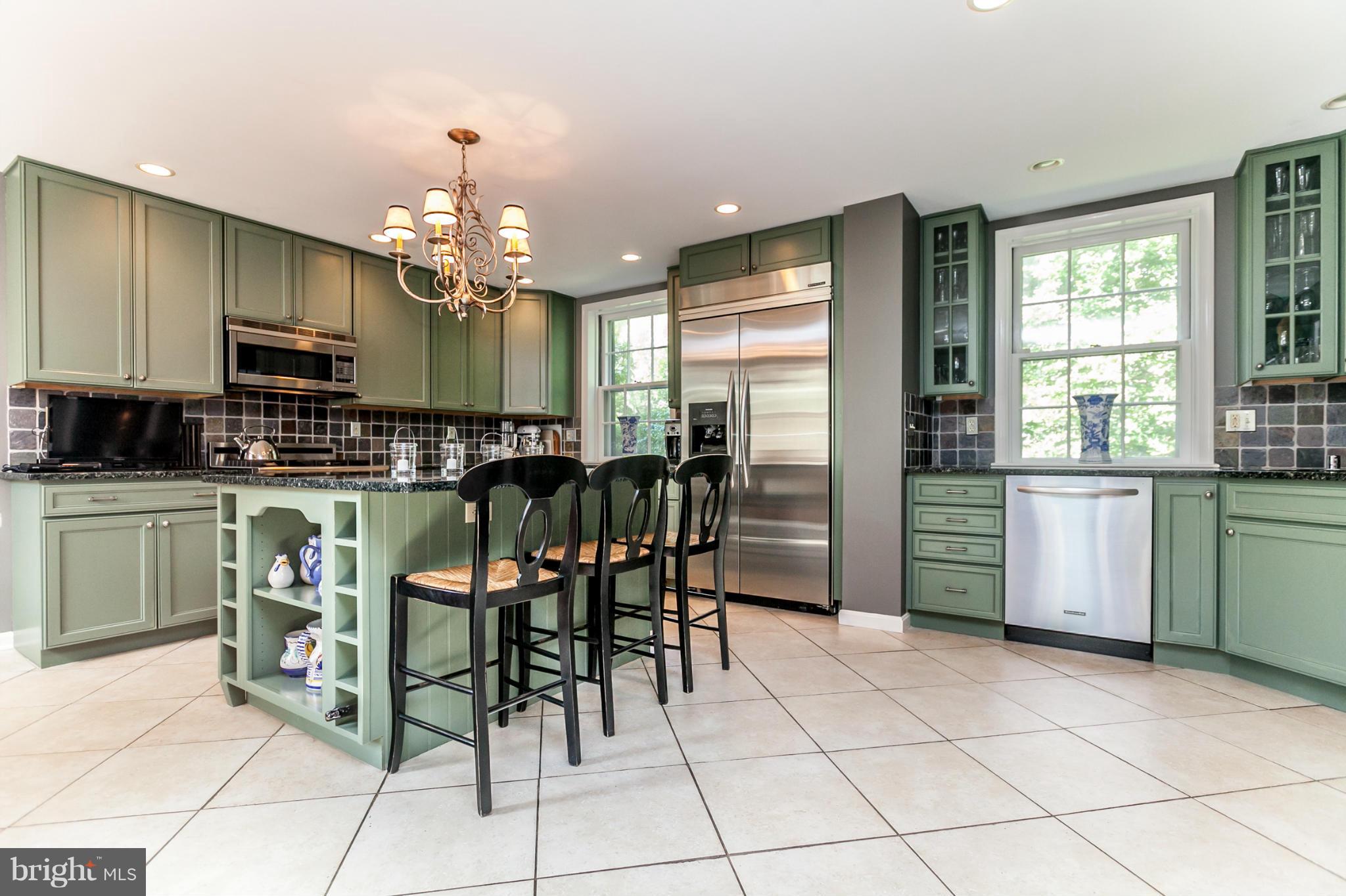 219 Paddington Road Baltimore, MD 21212 - Photo 4 of 30 a kitchen with cabinets and chairs