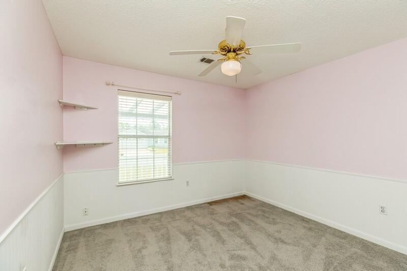 439 Northview Lane Crestview, FL 32536 - Photo 15 of 26 an empty room with windows and fan