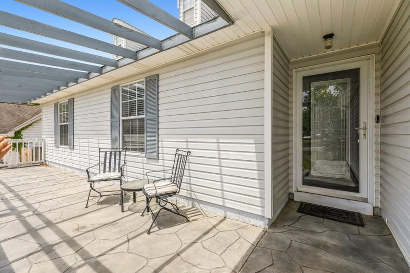 439 Northview Lane Crestview, FL 32536 - Photo 4 of 26 a view of a porch with a bench and chairs