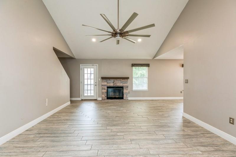 439 Northview Lane Crestview, FL 32536 - Photo 5 of 26 a view of a livingroom with a fireplace a ceiling fan and wooden floor