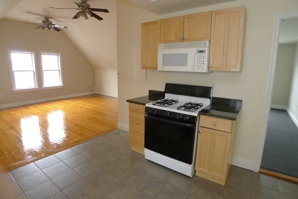a kitchen with a stove and a white cabinet