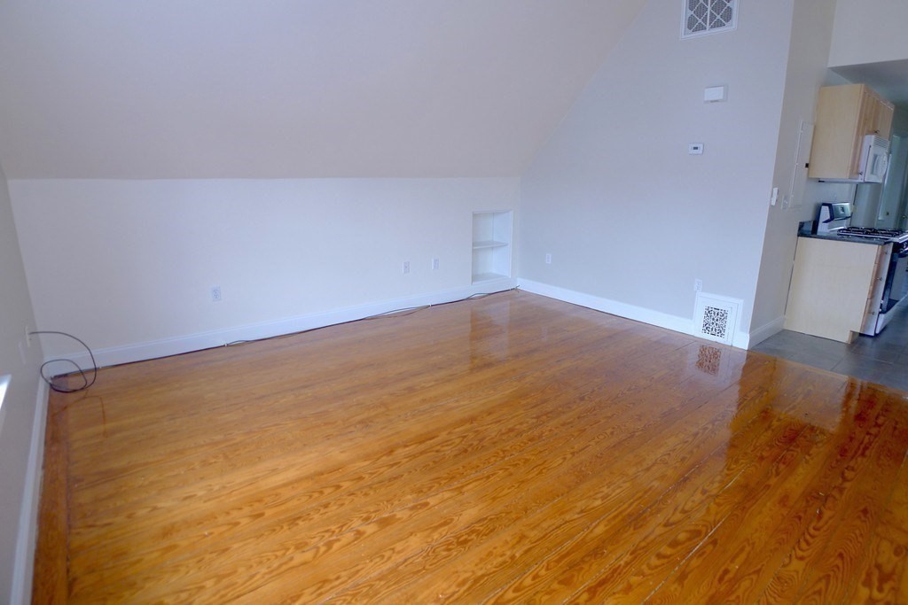 100 Lonsdale Street, Unit 3 Boston, MA 02124 - Photo 3 of 10 a view of empty room with wooden floor