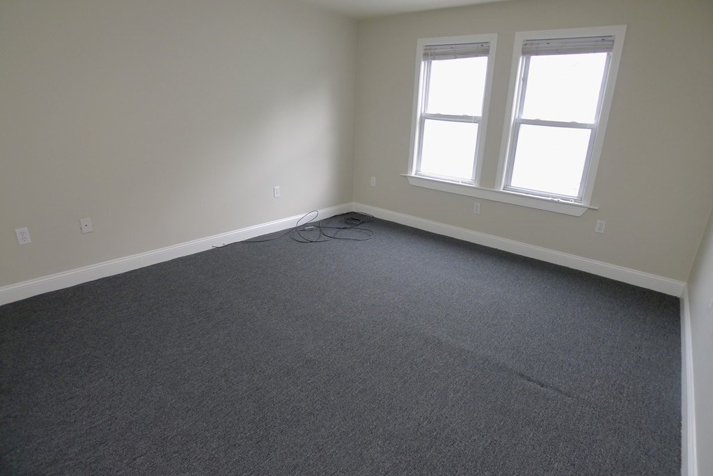 100 Lonsdale Street, Unit 3 Boston, MA 02124 - Photo 5 of 10 an empty room with a window