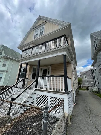 a view of a house with wooden fence
