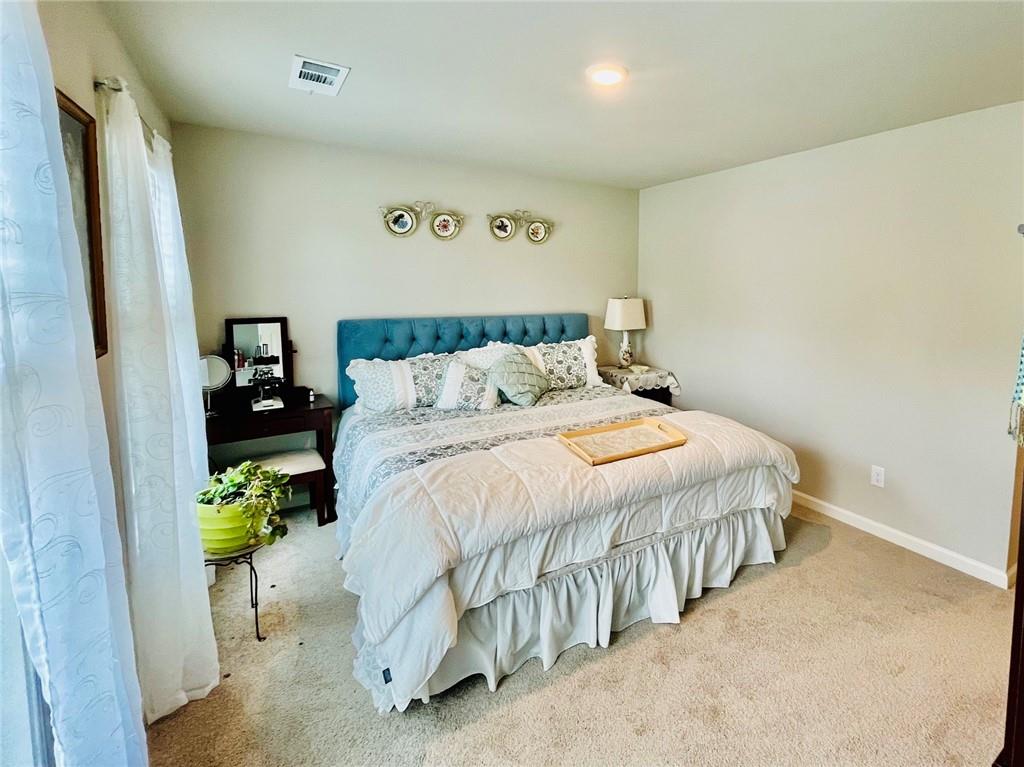 3015 Winding Ridge Waleska, GA 30183 - Photo 29 of 40 a bedroom with a bed and a wall painting