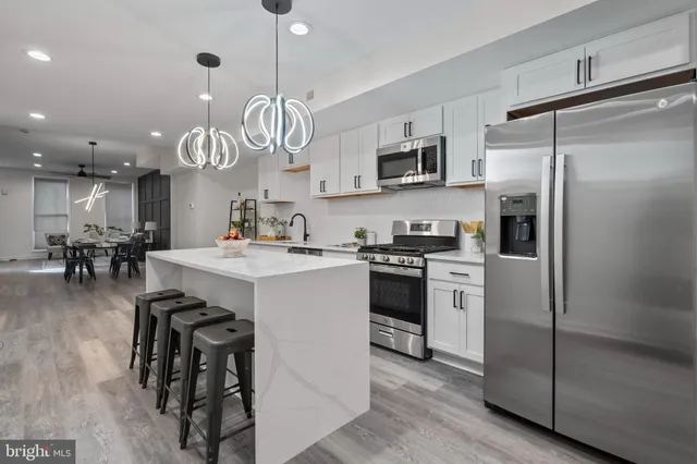 a kitchen with stainless steel appliances a refrigerator a stove microwave and cabinets