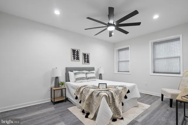 a bedroom with a bed and a ceiling fan