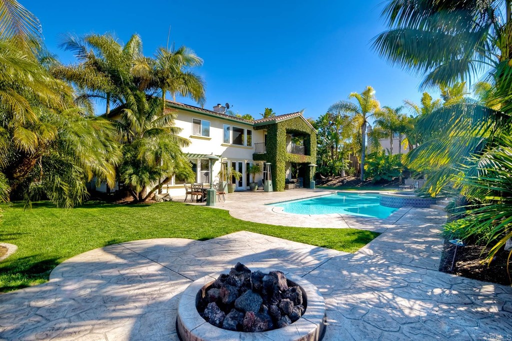 710 West Bluff Drive Encinitas, CA 92024 - Photo 3 of 12 a view of a white house with a yard and plants