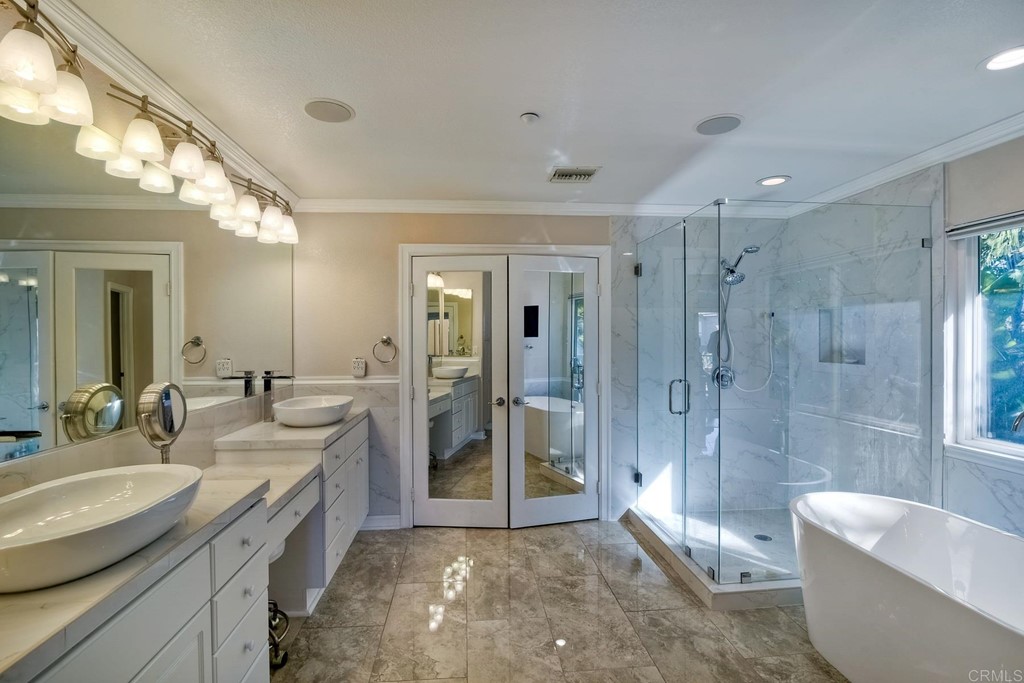710 West Bluff Drive Encinitas, CA 92024 - Photo 10 of 12 a spacious bathroom with a bathtub shower sink mirror and toilet