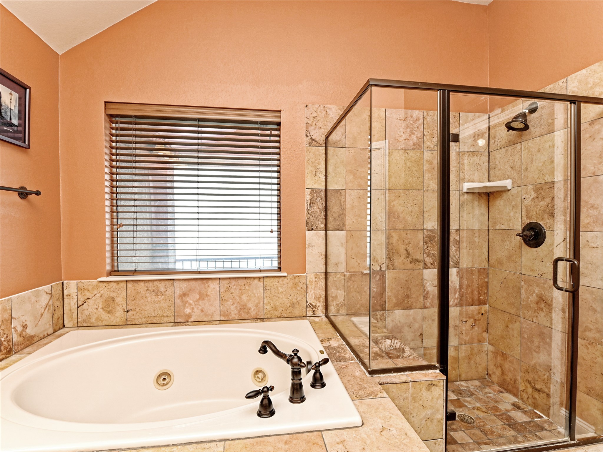 230 Sunrise Ridge Loop Austin, TX 78738 - Photo 20 of 27 Relax in the inviting soaking tub or refresh in the tiled walk-in shower of this private bathroom retreat.