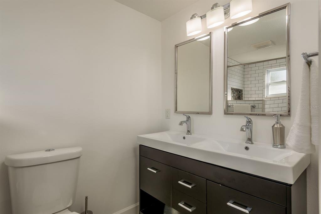 9110 Rainbow Lane Port Richey, FL 34668 - Photo 19 of 29 a bathroom with a sink toilet and mirror