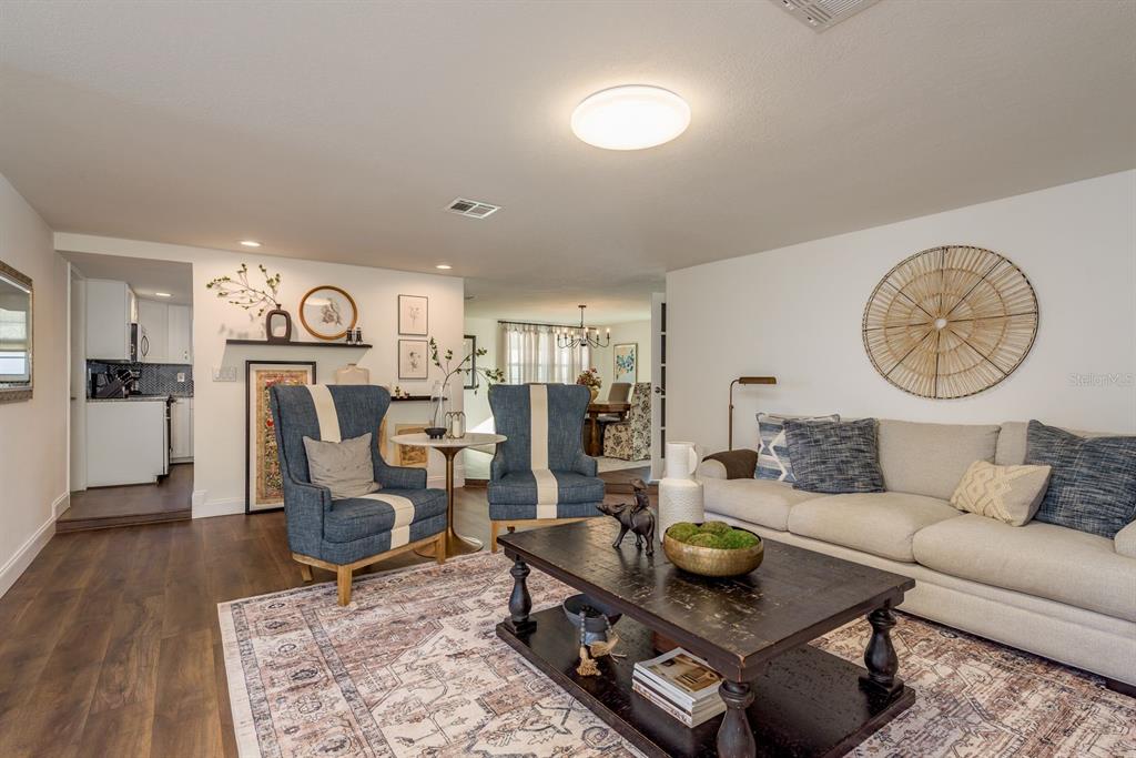 9110 Rainbow Lane Port Richey, FL 34668 - Photo 2 of 29 a living room with furniture and wooden floor
