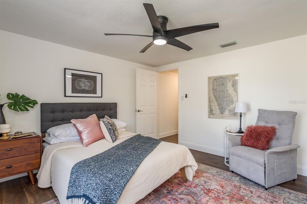 9110 Rainbow Lane Port Richey, FL 34668 - Photo 25 of 29 a bedroom with a bed couch and window