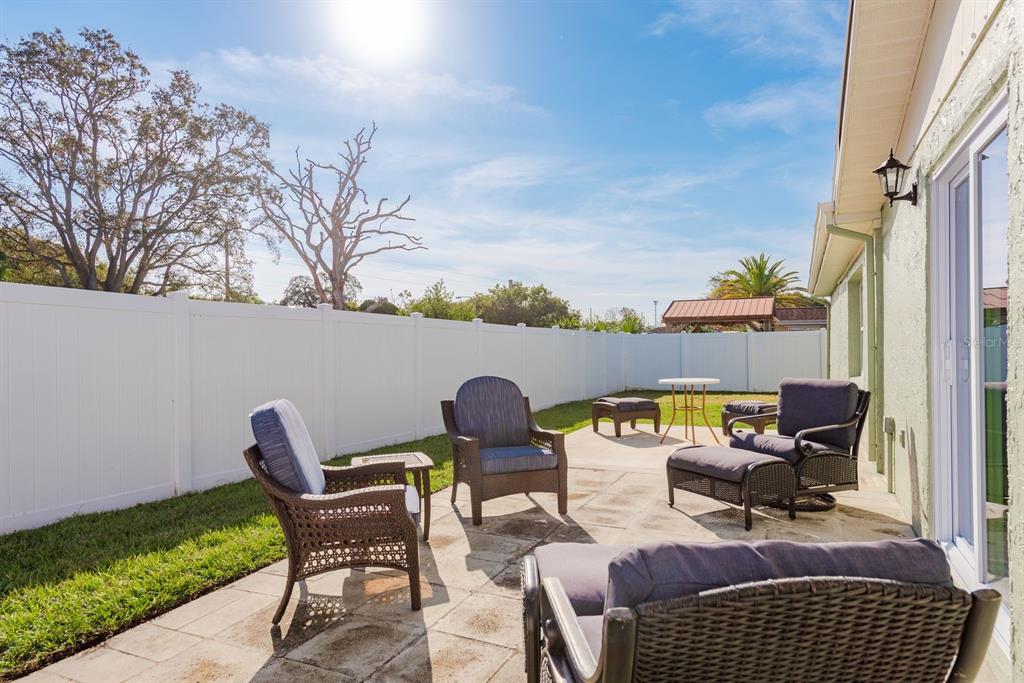 9110 Rainbow Lane Port Richey, FL 34668 - Photo 26 of 29 a view of a chairs and table in the back yard of the house