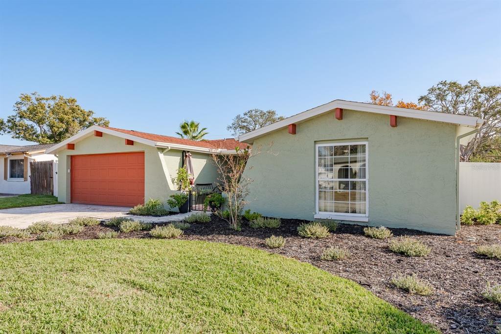 9110 Rainbow Lane Port Richey, FL 34668 - Photo 6 of 29 a front view of a house with garden