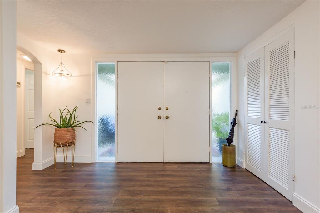 9110 Rainbow Lane Port Richey, FL 34668 - Photo 8 of 29 a view of an entryway with wooden floor