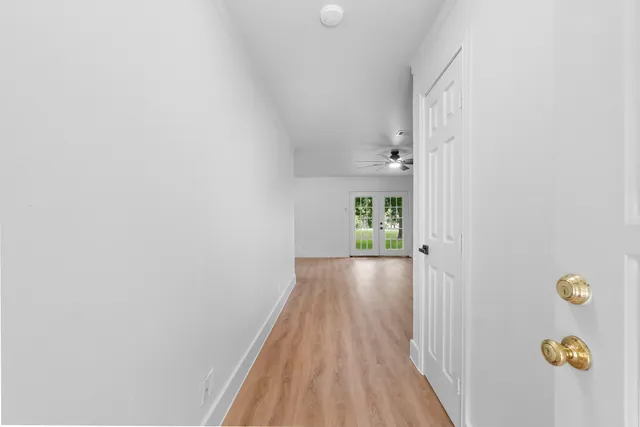 a view of hallway with wooden floor