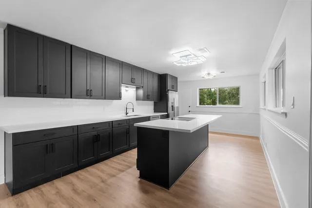 a kitchen with a sink and cabinets