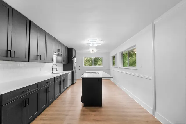 a kitchen with a cabinets and wooden floor