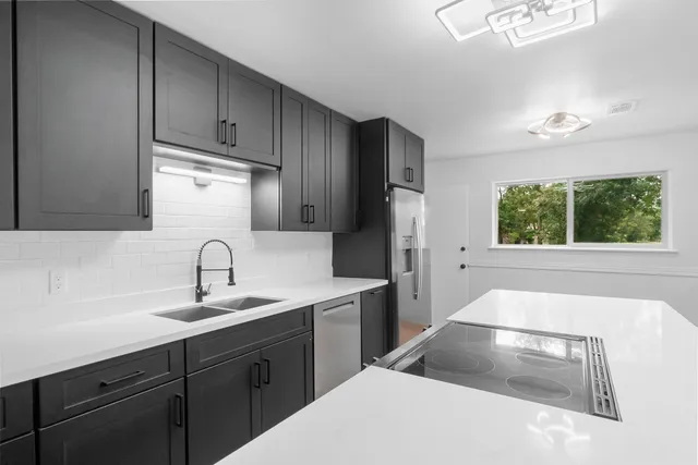 a kitchen with a sink cabinets and window